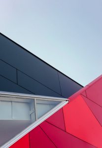 A low-angle view of a modern geometric building facade with bold colors in London, ON, Canada.