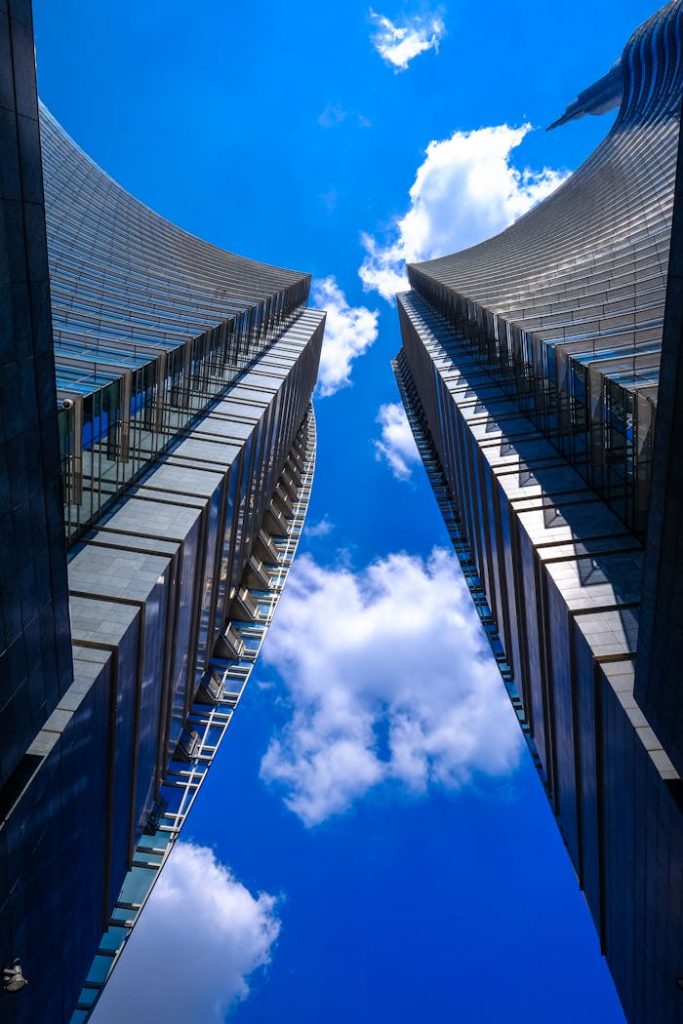 Low angle view of modern skyscrapers against a blue sky in Milan, Italy.